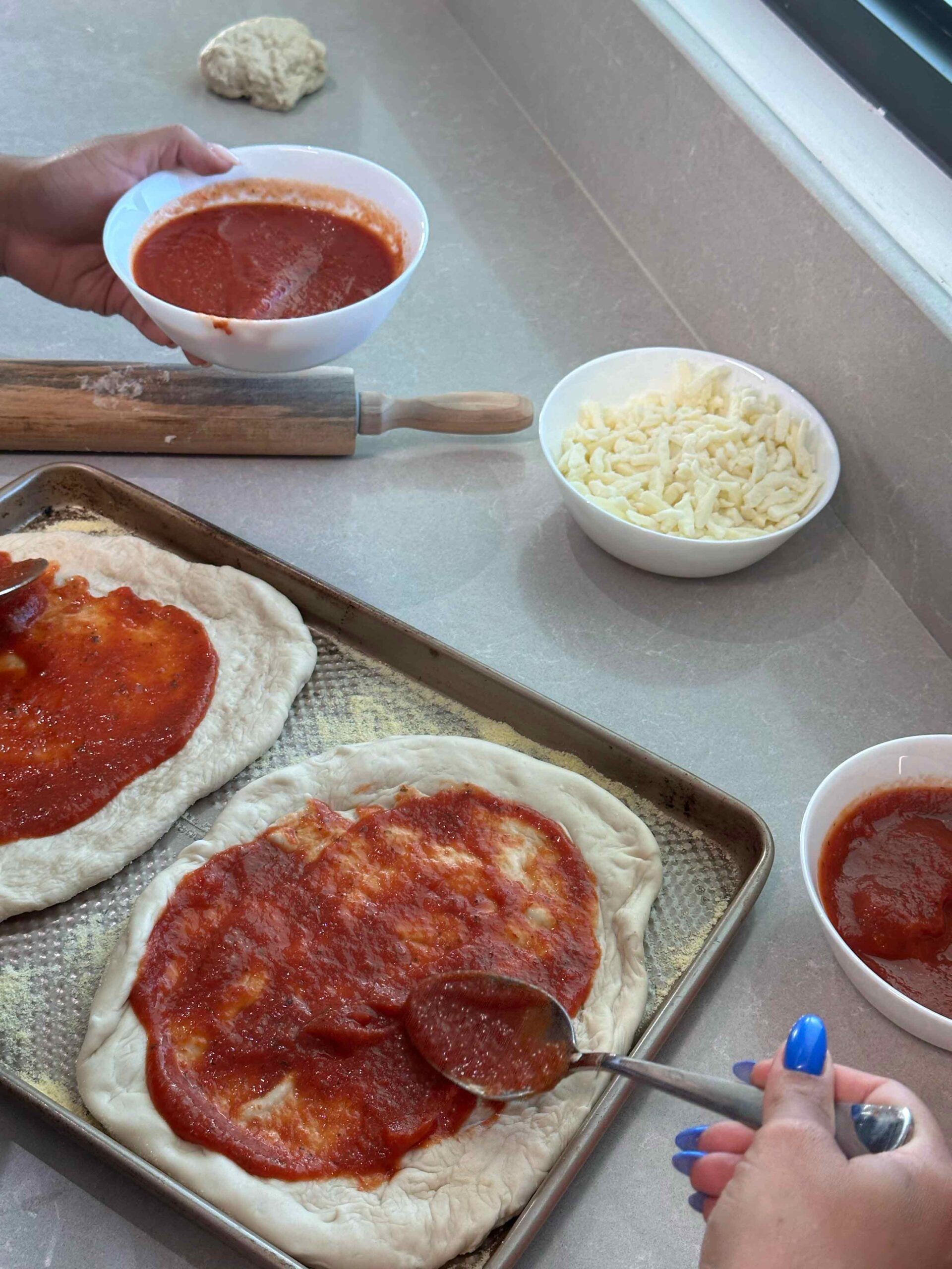 Homemade pepperoni pizzas with cheese and tomato sauce prepared for a group celebration
